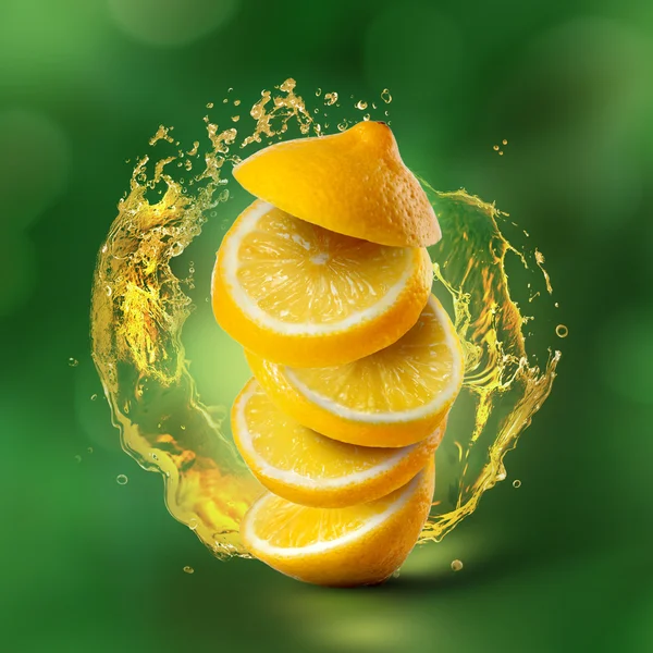 Lemon flying in air with juice splash on green — Stock Photo, Image