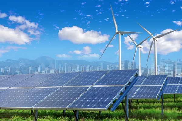 Solar panels and wind turbines with city — Stock Photo, Image