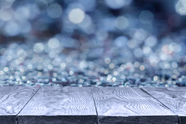 Wooden table and blue bokeh abstract background — Stock Photo, Image