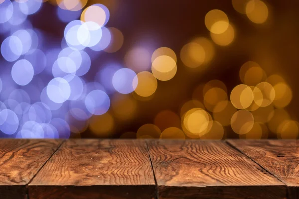 Fából készült asztal a sárga bokeh a háttérben — Stock Fotó