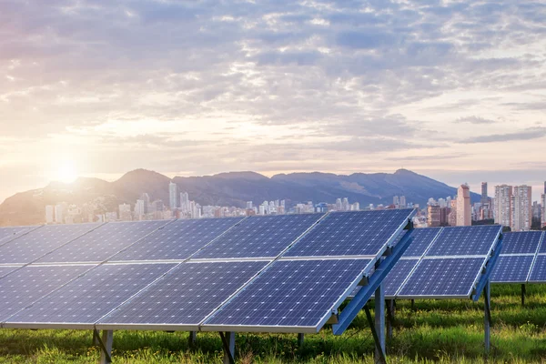 Solar panels with city on background — Stock Photo, Image