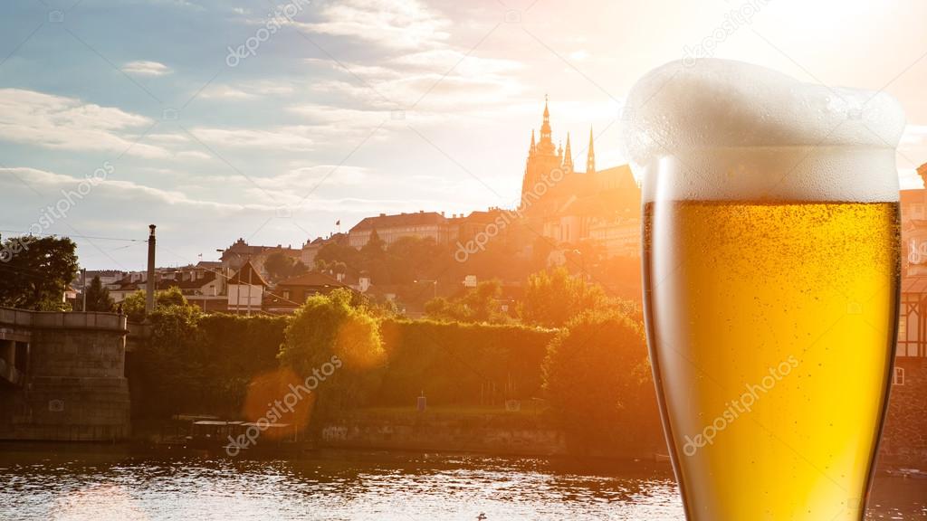 Glass of beer against view of Prague