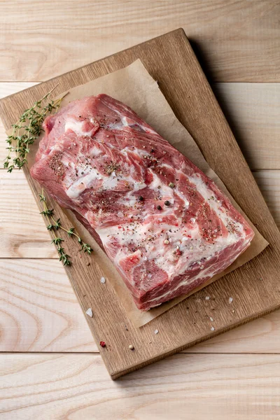 Foto av rått kött. Grishals med örter — Stockfoto