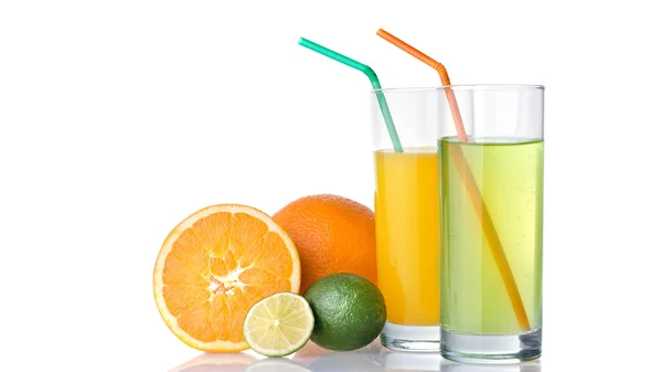 Glasses of orange and lime juices with orange and lime fruits — Stock Photo, Image