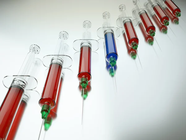 Red syringe among blue ones — Stock Photo, Image