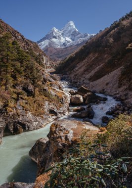 Ama Dablam peak and himalayan river clipart