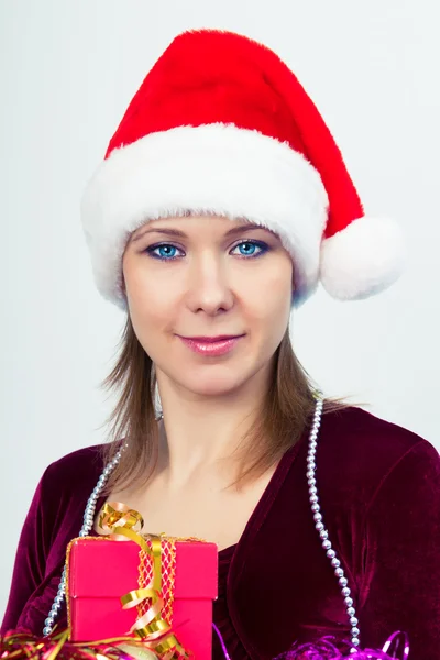 Happy girl in santa hat with gift boxes — Stock Photo, Image