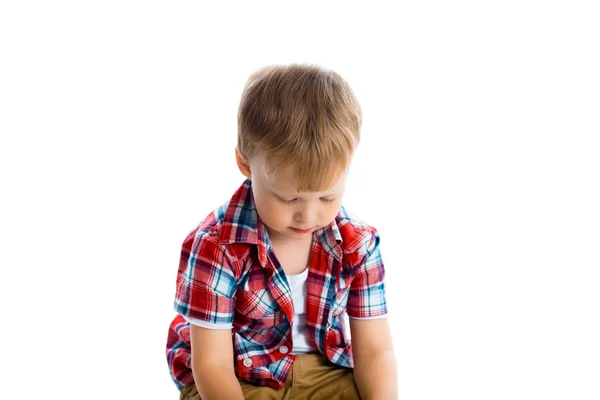 Petit garçon en chemise à carreaux sur un blanc — Photo