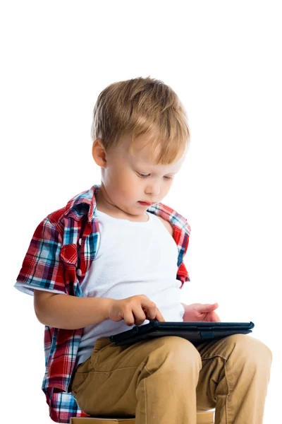 Boy in a plaid shirt with a tablet computer — Stock Photo, Image