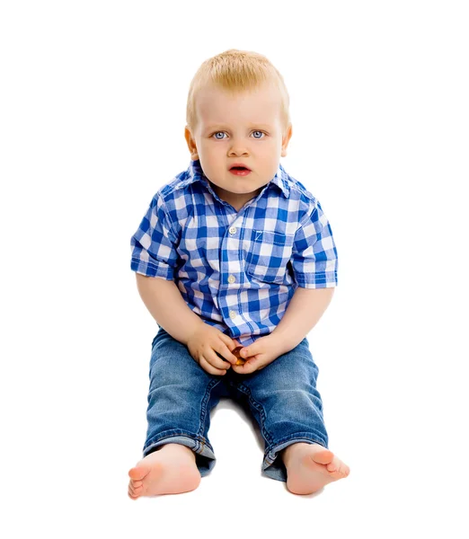 Little boy in a plaid shirt and jeans Stock Picture