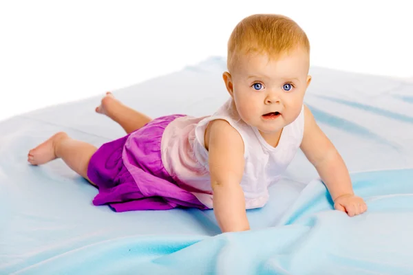 Crawling across the blue plaid baby girl — Stock Photo, Image