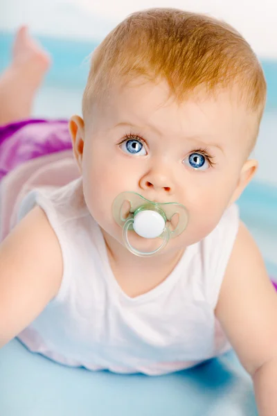 Beautiful baby with a pacifier. Close-up. Studio photo — Stock Photo, Image