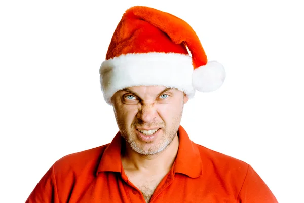 Unshaven angry man in a red shirt and Santa hats. Studio. isolat — Stock Photo, Image