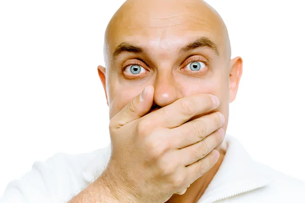 Bald frightened man in a white jacket covers her mouth with his — Stock Photo, Image