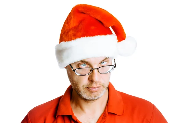 Unshaven slanting eyes Man in Santa hat. Isolated on white. Humo — Stock Photo, Image