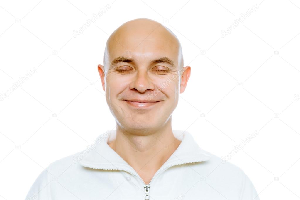 Bald smiling man with his eyes closed. Isolated. Studio