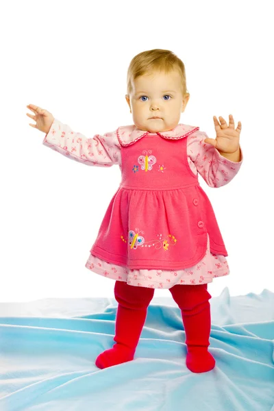 Baby girl in a dress standing — Stock Photo, Image