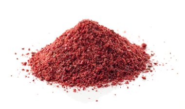 heap of dried cranberry powder macro isolated on white background, selective focus