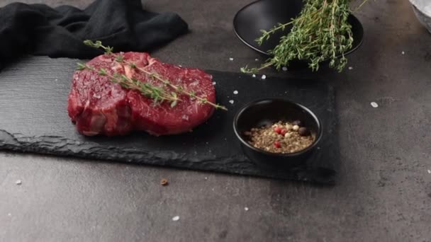 Čerstvý Syrový Hovězí Steak Zdobený Kořením Tymiánem Černé Kamenné Desce — Stock video