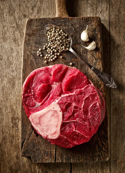 Fresh raw meat on wooden cutting board — Stock Photo, Image