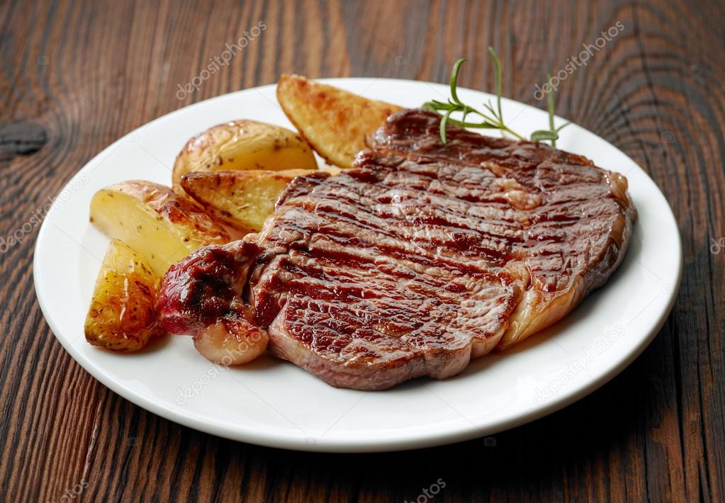 grilled beef steak and potatoes