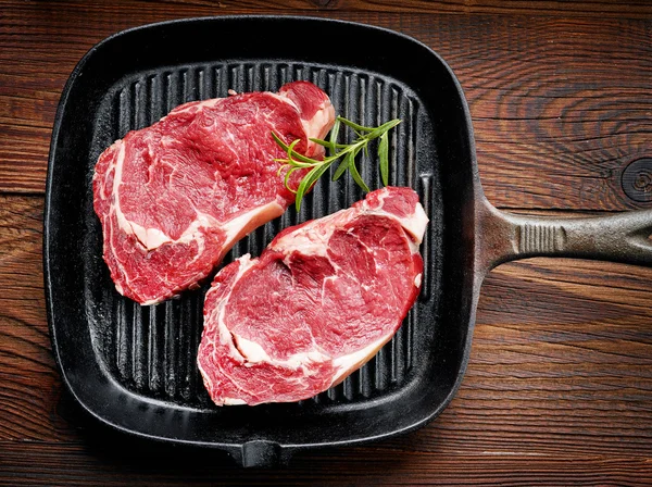 Fresh raw beef steak on cooking pan — Stock Photo, Image