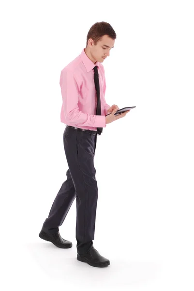 The boy in a pink shirt goes holding tablet PC — Stock Photo, Image