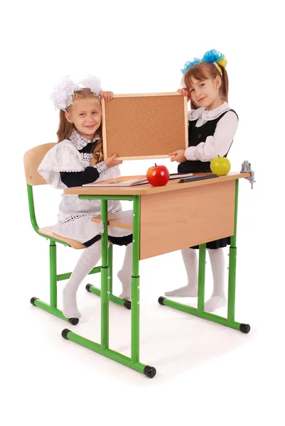 Little school girls hold empty chalkboard — Stock Photo, Image