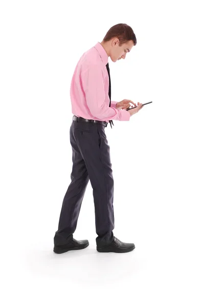 The boy in a pink shirt goes holding tablet PC — Stock Photo, Image