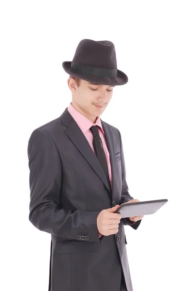 Niño en un traje negro sostener una tableta PC —  Fotos de Stock