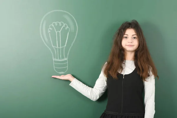 Pre Adolescent Girl Holding Painted Electric Bulb School Board Background — Stock Photo, Image