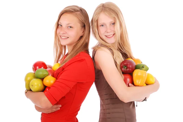 Twee meisje bedrijf vers fruit — Stockfoto