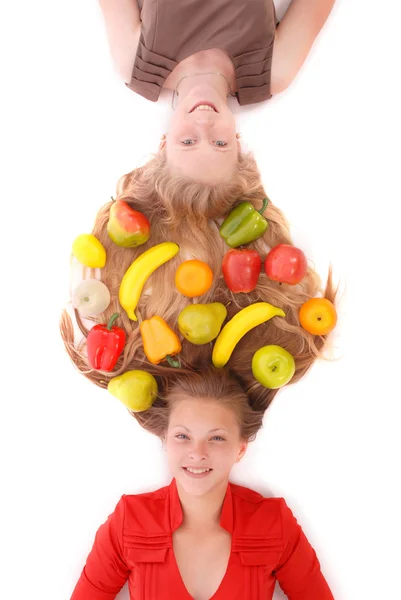 Portrait two girls with intertwined hairs and fruits — Stock Photo, Image