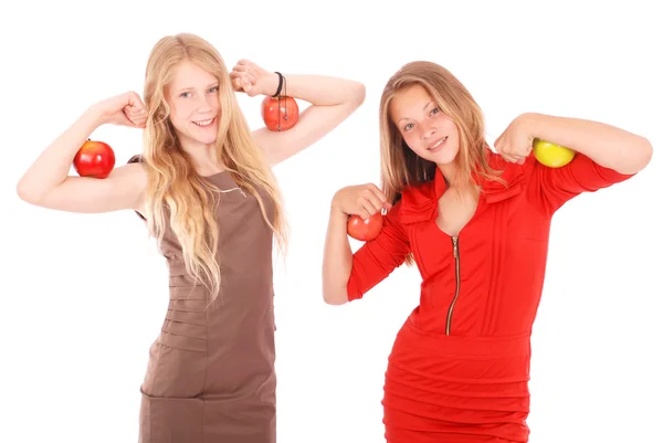 Two girls holding apples on her biceps — Stock Photo, Image