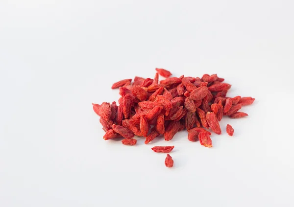 Dry red goji berries on white textured background — Stock Photo, Image