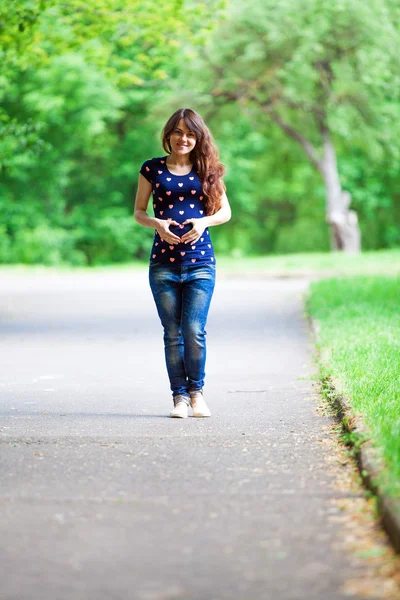 Mulher grávida andando no parque — Fotografia de Stock