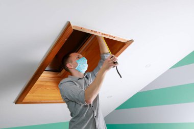 İşçi evdeki çatı penceresini kurar ve kontrol eder