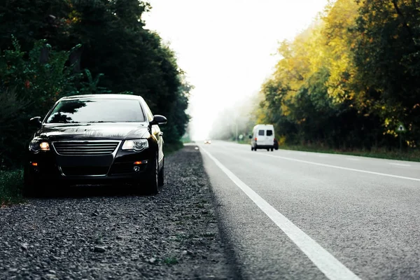 black car on asphalt road