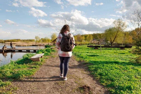 girl with a backpack travels. happy girl in nature