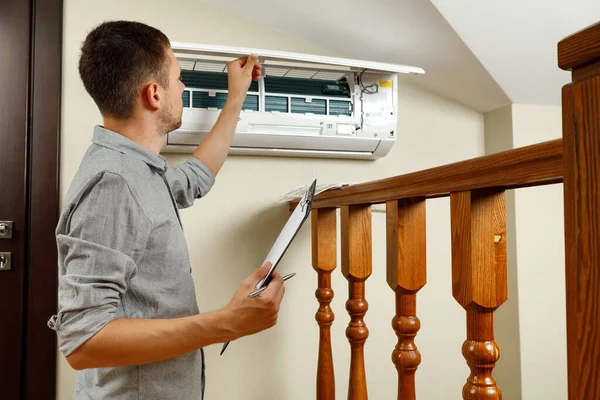 Male Technician Cleaning Air Conditioner Indoors — Stock Photo, Image