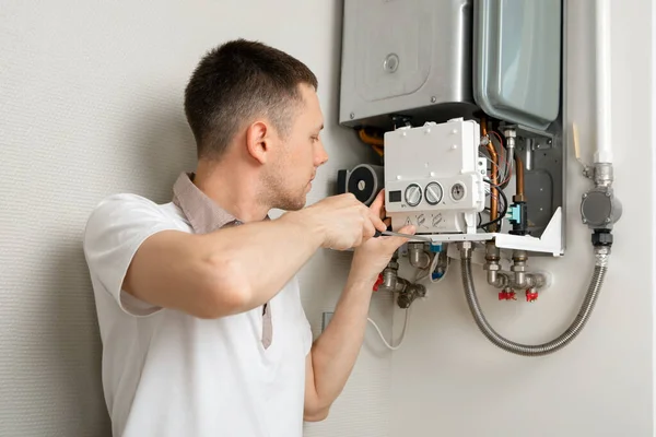 a man repairing a boiler in a medical mask