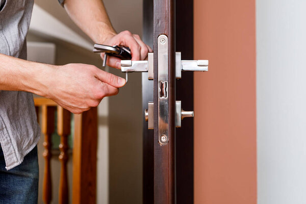 a man repairing a doorknob