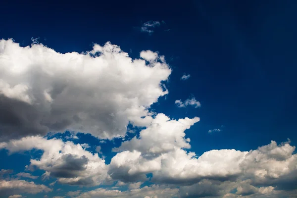 Blauwe hemel met witte en grijze wolken — Stockfoto