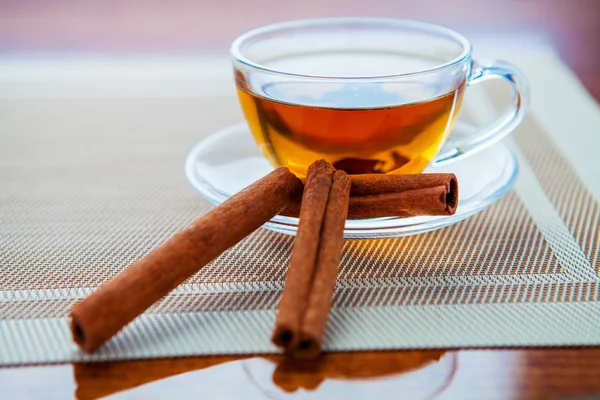 The cup of tea is isolated on a wooden background — Stock Photo, Image