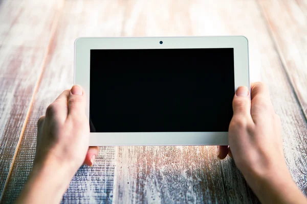 white tablet in hands