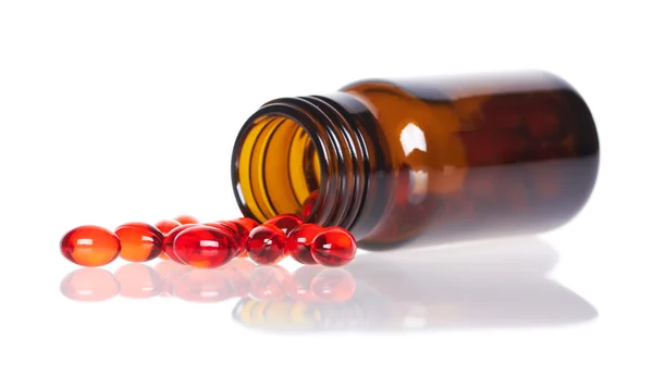 Rote Pillen und Tablettenflasche — Stockfoto