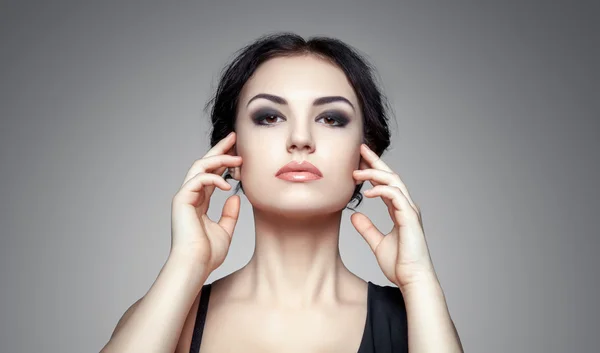 Portrait of beautiful female model on gray background — Stock Photo, Image