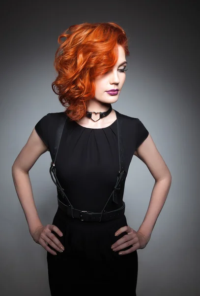 Beautiful woman with red hair in a black dress — Stock Photo, Image