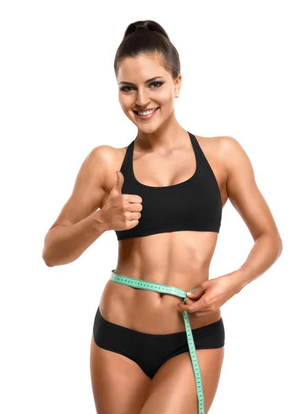 Athletic woman measuring her waist  and showing thumb up isolate — Stock Photo, Image