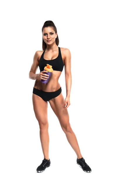 Athletic young woman with protein shake bottle — Stock Photo, Image